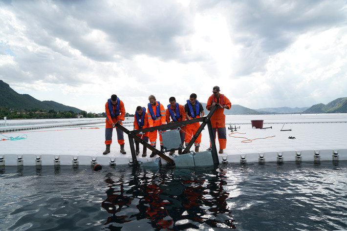 Workers push one of the frames underneath a floating element before connecting it with screws, April 2016. Photo: Wolfgang Volz.