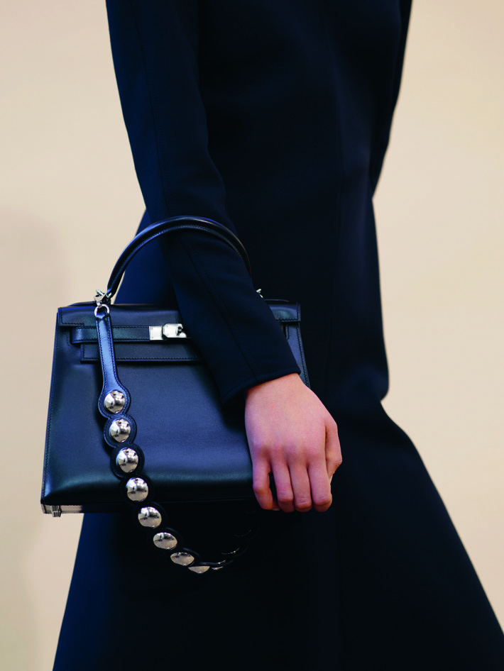 Shoulder bag embellished with metal inserts that enhance the refined shade of blue. Fall/Winter Collection 2018.