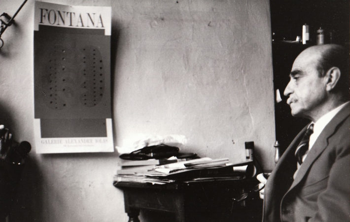 Lucio Fontana in his studio, 1966. Photo: Giuseppe Loy, © Archivio Giuseppe Loy.   